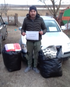 A volunteer takes blankets to the border